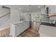 Modern kitchen with stainless appliances, an island with sink, and an open floor plan to the living area at 2617 Chert Ln, Raleigh, NC 27610