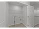 Bright laundry room with tile flooring, washer and dryer hookups, and wire shelving at 2617 Chert Ln, Raleigh, NC 27610