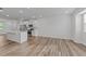 Spacious living area featuring hardwood floors, neutral walls, and an open layout to the kitchen with stainless appliances at 2617 Chert Ln, Raleigh, NC 27610