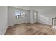 Bright living room featuring hardwood floors, large windows providing natural light, and neutral walls at 2617 Chert Ln, Raleigh, NC 27610