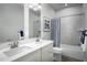 Well-lit bathroom featuring double sinks and a shower-tub combination, designed for comfort and style at 2881 Foster Woods Dr, Apex, NC 27502