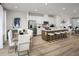 Modern open concept features large quartz-topped island with bar seating, stainless appliances, and dining area at 2881 Foster Woods Dr, Apex, NC 27502