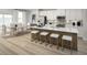 Stylish kitchen with white cabinets, stainless steel appliances, island with seating, and open dining area at 2881 Foster Woods Dr, Apex, NC 27502