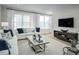 Cozy living room with bright light, plush sofas, designer throw pillows, and sleek coffee table at 2881 Foster Woods Dr, Apex, NC 27502