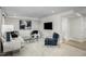 Cozy living room featuring plush seating, a large-screen TV, and a soothing color palette for relaxation at 2881 Foster Woods Dr, Apex, NC 27502