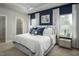 Serene main bedroom with tray ceilings, a king-sized bed, and ample natural light, creating a calming retreat at 2881 Foster Woods Dr, Apex, NC 27502