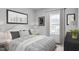 Bright bedroom featuring a queen-sized bed, neutral walls, and a large window that brings in natural light at 2885 Foster Woods Dr, Apex, NC 27502