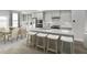 Modern kitchen features a spacious island with bar seating, stainless steel appliances, and ample cabinet space at 2885 Foster Woods Dr, Apex, NC 27502