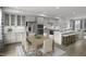 Open-concept kitchen and dining area with stainless steel appliances, a large island, and stylish decor at 2885 Foster Woods Dr, Apex, NC 27502