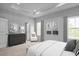 Serene Primary bedroom with tray ceilings, ensuite bathroom, and neutral tones for a relaxing retreat at 2885 Foster Woods Dr, Apex, NC 27502