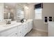 Elegant bathroom featuring double sinks, quartz countertops, a large mirror, and a tiled shower at 2889 Foster Woods Dr, Apex, NC 27502