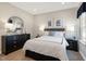 Inviting bedroom with neutral walls, a king bed, dark furniture, and bright windows providing ample light at 2889 Foster Woods Dr, Apex, NC 27502