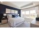 Serene main bedroom with tray ceilings, a king bed, and bright windows offering picturesque outdoor views at 2889 Foster Woods Dr, Apex, NC 27502