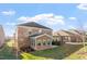 Exterior view of a brick home with a patio and a well-maintained lawn, ideal for outdoor living at 330 Macallan Dr, Burlington, NC 27215