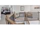 Upstairs landing with seating area leading to a Primary bedroom with a comfortable king bed at 330 Macallan Dr, Burlington, NC 27215