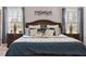Spacious bedroom with dark wood furniture, ceiling fan, and two windows that let in lots of light at 330 Macallan Dr, Burlington, NC 27215