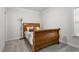 Comfortable bedroom with a wooden bed frame, soft lighting, and neutral color scheme at 330 Macallan Dr, Burlington, NC 27215