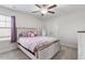 Cozy bedroom with a full bed, purple comforter set, ceiling fan and a window with blind and curtains at 330 Macallan Dr, Burlington, NC 27215