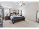 Spacious bedroom with dark wood furniture, ceiling fan, and two windows letting in ample sunlight at 330 Macallan Dr, Burlington, NC 27215