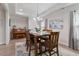 The dining room includes a wooden table set for six, complemented by a piano and soft natural light at 330 Macallan Dr, Burlington, NC 27215