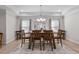 Elegant dining room features a wooden table set for six, chandelier, and decorative painting at 330 Macallan Dr, Burlington, NC 27215