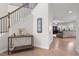 Inviting entryway with staircase, console table, decor, and views into the living room with hardwood floors at 330 Macallan Dr, Burlington, NC 27215