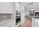 Kitchen with built-in stainless steel appliances, gray backsplash, and white cabinets at 330 Macallan Dr, Burlington, NC 27215