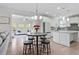 Open-concept kitchen with white cabinets, stainless steel appliances, and a breakfast nook at 330 Macallan Dr, Burlington, NC 27215