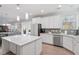 Kitchen featuring white cabinets, granite countertops, stainless steel appliances, and an island at 330 Macallan Dr, Burlington, NC 27215