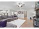Comfortable living room featuring a gray sectional sofa, fireplace, hardwood floors, and soft lighting at 330 Macallan Dr, Burlington, NC 27215