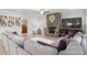 Spacious living room featuring a stone fireplace, ceiling fan, plush sectional sofa, and hardwood floors at 330 Macallan Dr, Burlington, NC 27215