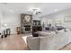 Inviting living room with a stone fireplace, hardwood floors, comfortable seating, and natural light at 330 Macallan Dr, Burlington, NC 27215