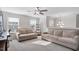 Bright living area with two sofas, ceiling fan and lots of natural light from two large windows at 330 Macallan Dr, Burlington, NC 27215