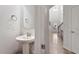 Charming powder room featuring a pedestal sink, decorative mirror, and modern fixtures at 330 Macallan Dr, Burlington, NC 27215
