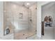Large walk-in shower with stone tile surround, rainfall shower head, and built-in bench at 330 Macallan Dr, Burlington, NC 27215