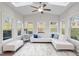 Bright sunroom with large windows and a ceiling fan overlooking the outdoors at 330 Macallan Dr, Burlington, NC 27215