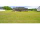Expansive backyard featuring a well-maintained lawn and a charming covered patio, perfect for outdoor relaxation and entertainment at 3345 Little Creek Church Rd, Clayton, NC 27520