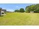 Expansive backyard with lush green lawn, a storage shed, and ample space at 3345 Little Creek Church Rd, Clayton, NC 27520