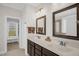 Double vanity bathroom featuring framed mirrors, modern lighting, and a walk-in closet at 3345 Little Creek Church Rd, Clayton, NC 27520