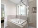 Relaxing bathroom featuring a soaking tub, a separate shower, and tiled walls at 3345 Little Creek Church Rd, Clayton, NC 27520