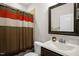 Clean bathroom featuring a vanity, mirror, toilet, and shower with a decorative curtain at 3345 Little Creek Church Rd, Clayton, NC 27520
