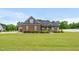 Charming brick and vinyl home with lush green lawn and manicured landscaping at 3345 Little Creek Church Rd, Clayton, NC 27520