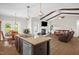 Open-concept living space featuring vaulted ceiling, exposed wood beams, and a cozy fireplace at 3345 Little Creek Church Rd, Clayton, NC 27520