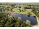 Overhead shot of a property with mature trees and a pristine pond at 3540 Sellars Rd, Mebane, NC 27302