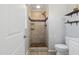 Modern bathroom features a beautifully tiled walk-in shower with a unique pebble floor and floating shelves at 3540 Sellars Rd, Mebane, NC 27302