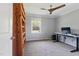 A bedroom featuring a dark-blade ceiling fan, a computer desk, carpeted floors, and a wooden bookcase at 3540 Sellars Rd, Mebane, NC 27302