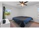 A bright bedroom with a ceiling fan and carpet, offering comfort and a pleasant view from the large window at 3540 Sellars Rd, Mebane, NC 27302