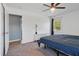A lovely bedroom with a ceiling fan and carpet, featuring a large window and a simple aesthetic at 3540 Sellars Rd, Mebane, NC 27302