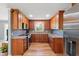 Well-lit kitchen with wood cabinets and stainless steel appliances at 3540 Sellars Rd, Mebane, NC 27302