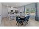 Bright dining area with modern table, chairs, and large windows offering ample natural light at 3714 Rosebush Dr, Zebulon, NC 27597